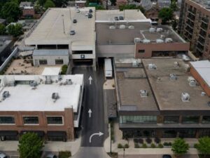 Aerial view of dense development with shared driveway, loading route, parking access, and marked property boundaries.